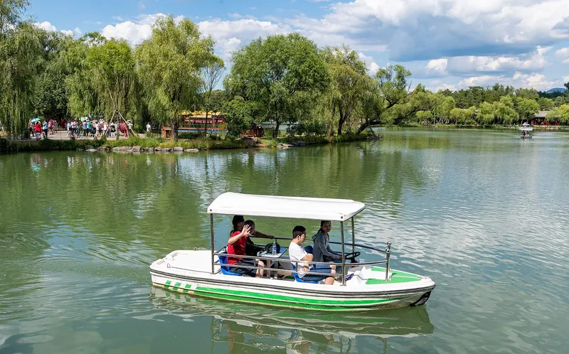 The lotus lakes and pavilions of the Mountain Resort in Chengde, with hills rising behind the water