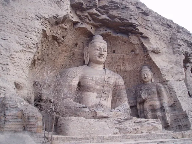 Ancient Buddha statues carved into a cliff at the Longmen Grottoes near Luoyang
