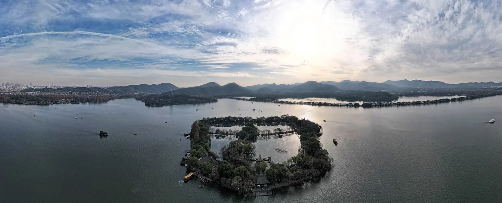 West Lake at dusk with the Leifeng Pagoda silhouette and willow-lined causeway, Hangzhou