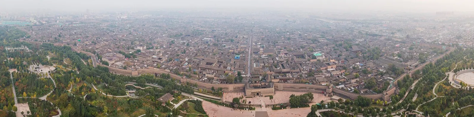 Lantern-lined street and city gate of the walled old town of Pingyao at dusk