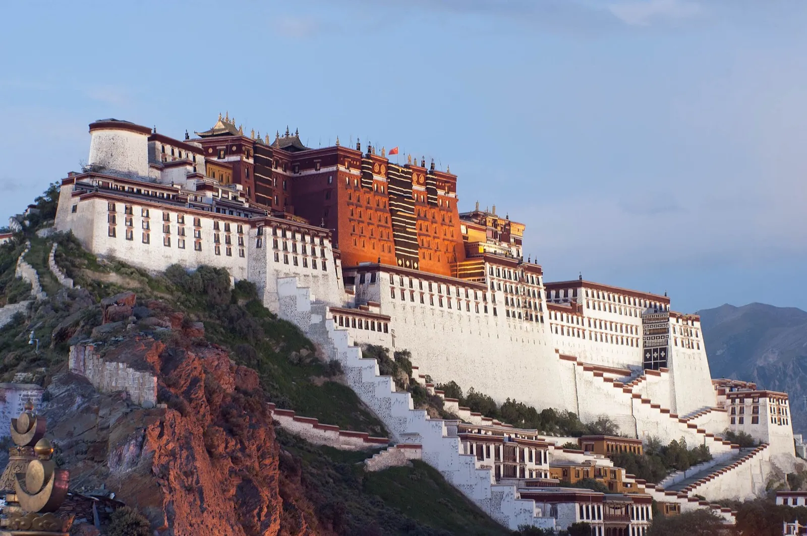 Tibetan prayer flags strung against a deep blue Himalayan sky above whitewashed buildings in Lhasa