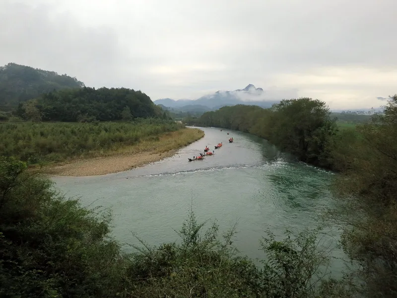 Bamboo rafts drifting the Nine-Bend River beneath Wuyishan's orange Danxia cliffs